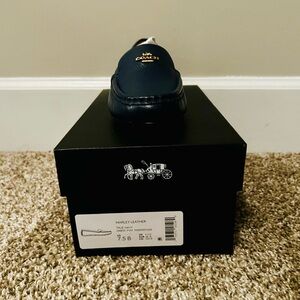Coach Women’s Navy Leather Slip-Ons.